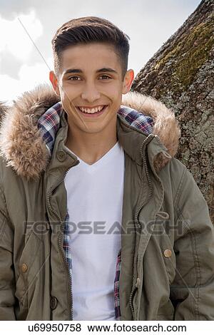 Stock Photo - Portrait of teenage boy in parka jacket. Fotosearch