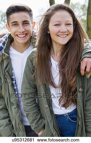 Stock Image - Portrait of teenage couple in parka jackets. Fotosearch