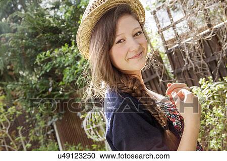 Portrait of teenage girl in straw hat in garden View Large Photo Image Stock Image - Portrait of teenage girl in straw hat in garden. Fotosearch