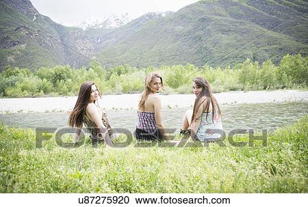 Stock Image - Portrait of three female friends next to Toce river, Piemonte, Italy. Fotosearch