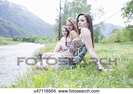 Portrait of three female friends on riverbank, Piemonte, Italy View Large Photo Image Picture - Portrait of three female friends on riverbank, Piemonte, Italy. Fotosearch