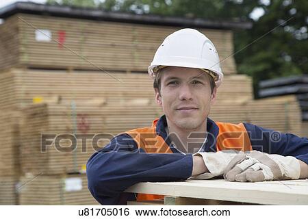 Portrait of young male worker in timber yard View Large Photo Image Stock Photograph - Portrait of young male worker in timber yard. Fotosearch
