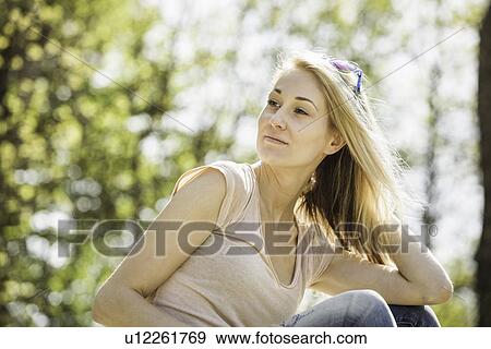 Portrait of young woman gazing calmly in forest View Large Photo Image Stock Photo - Portrait of young woman gazing calmly in forest. Fotosearch