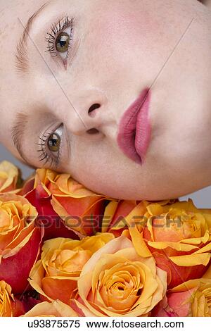 Portrait of young woman, holding bunch of roses View Large Photo Image Stock Photography - Portrait of young woman, holding bunch of roses. Fotosearch