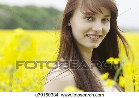 Portrait of young woman in yellow field View Large Photo Image Picture - Portrait of young woman in yellow field. Fotosearch