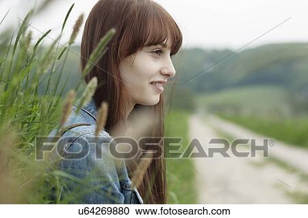 Portrait of young woman next to dirt track View Large Photo Image Stock Image - Portrait of young woman next to dirt track. Fotosearch