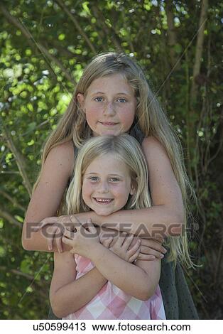 Sisters with arms around View Large Photo Image Stock Image - Sisters with arms around. Fotosearch