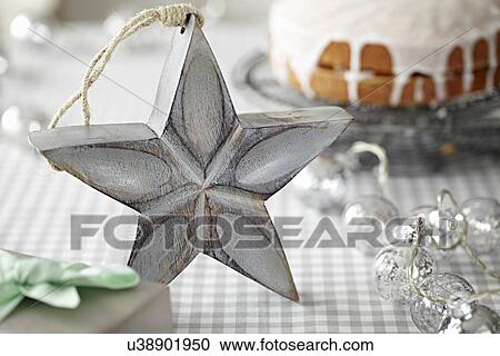 Stock Image - Star decoration in front of iced cake. Fotosearch