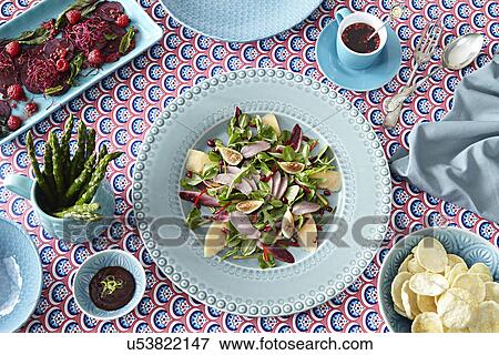 Stock Photo - Still life of foods on matching crockery. Fotosearch