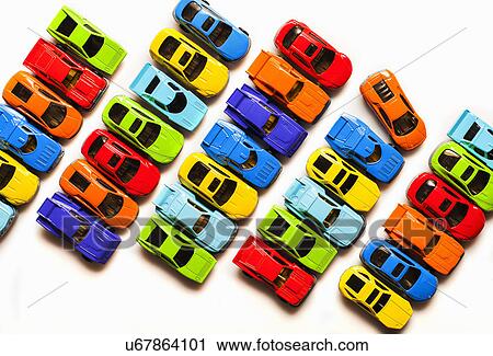 Stock Image - Still life with rows of colorful toy cars. Fotosearch