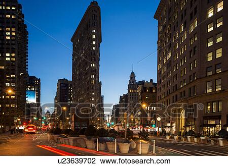 Stock Image - Street view of New York with Flat Iron Building in view. Fotosearch