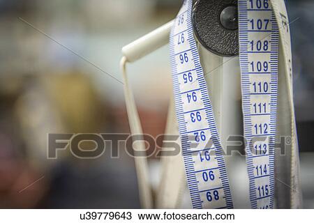 Stock Image - Tape measure in clothing factory, close up. Fotosearch
