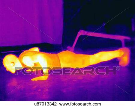 Stock Image - Thermal image of young male athlete doing push ups. The image shows the heat produced by the muscles. Fotosearch
