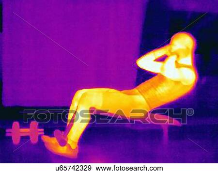 Stock Photo - Thermal image of young male athlete doing pull ups on weight bench. The image shows the heat produced by the muscles. Fotosearch