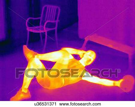 Stock Image - Thermal image of young man in training. The images shows the heat produced by the muscles. Fotosearch
