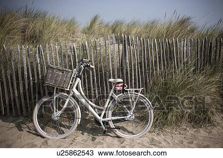 Traditional bicycle against sand dune fence, Vollendam, Netherlands View Large Photo Image Stock Image - Traditional bicycle against sand dune fence, Vollendam, Netherlands. Fotosearch