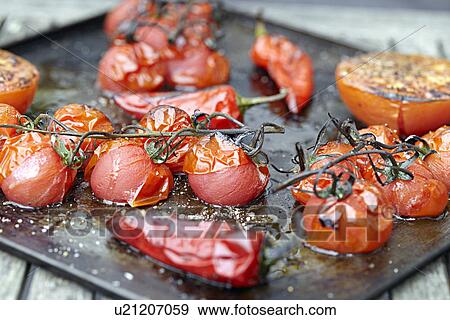 Tray of roasted tomatoes and chillis View Large Photo Image Stock Photo - Tray of roasted tomatoes and chillis. Fotosearch