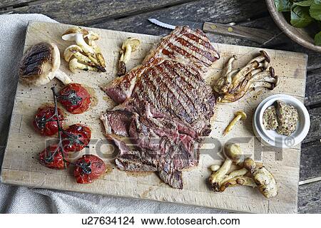 Picture - Tray of steak, mushrooms and tomatoes. Fotosearch