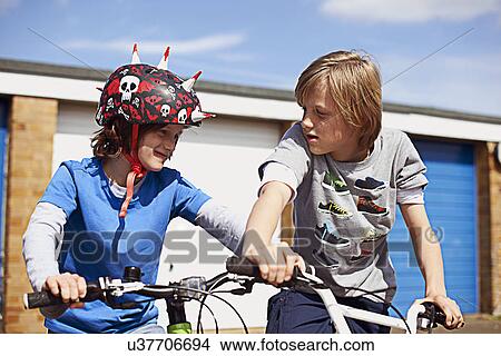 Two boys on bikes View Large Photo Image Picture - Two boys on bikes. Fotosearch