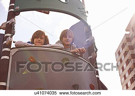 Stock Photography - Two boys on climbing frame. Fotosearch
