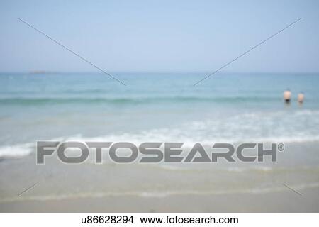 Two people paddling in sea, defocussed View Large Photo Image Picture - Two people paddling in sea, defocussed. Fotosearch