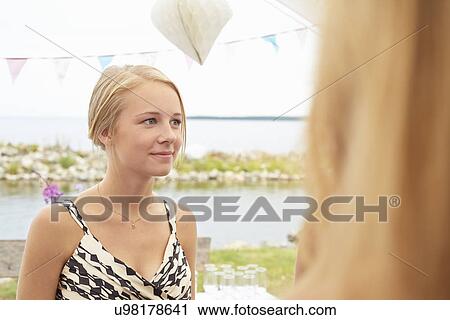 Two young female guests at wedding reception View Large Photo Image Stock Image - Two young female guests at wedding reception. Fotosearch