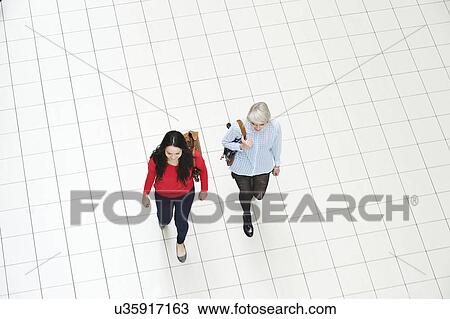 Two young women walking, high angle View Large Photo Image Stock Image - Two young women walking, high angle. Fotosearch