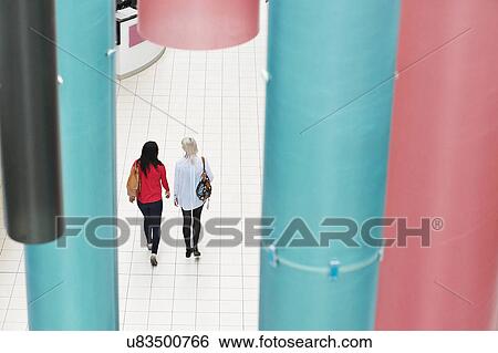 Two young women walking, high angle View Large Photo Image Stock Photograph - Two young women walking, high angle. Fotosearch