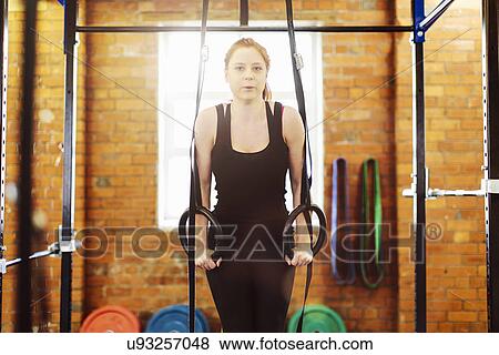 Woman pulling suspended rings in gym View Large Photo Image Stock Photo - Woman pulling suspended rings in gym. Fotosearch
