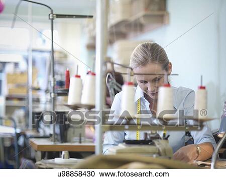 Worker sewing in clothing factory View Large Photo Image Stock Image - Worker sewing in clothing factory. Fotosearch