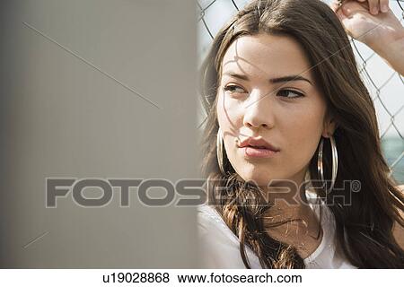 Young brunette woman wearing earrings View Large Photo Image Stock Photo - Young brunette woman wearing earrings. Fotosearch