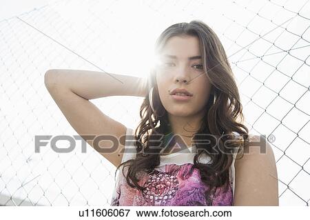 Young brunette woman with hand in hair View Large Photo Image Stock Photo - Young brunette woman with hand in hair. Fotosearch