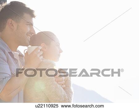 Stock Photography - Young couple drinking cups of coffee. Fotosearch