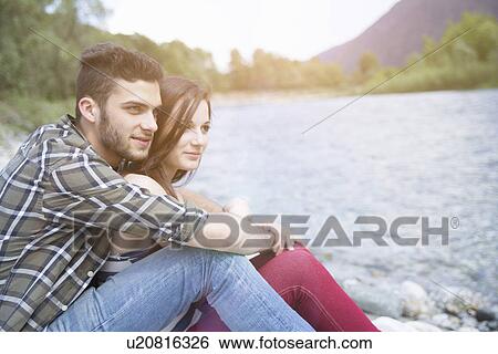 Young couple gazing on Toce riverbank, Piemonte, Italy View Large Photo Image Stock Photograph - Young couple gazing on Toce riverbank, Piemonte, Italy. Fotosearch