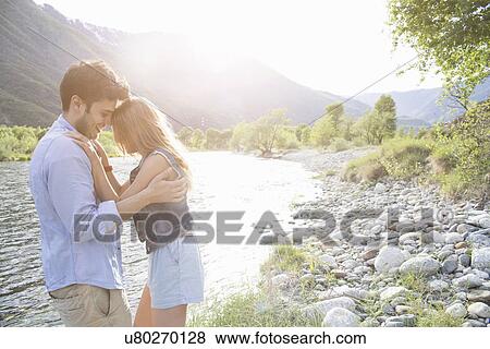 Young couple hugging on Toce riverbank, Piemonte, Italy View Large Photo Image Stock Photo - Young couple hugging on Toce riverbank, Piemonte, Italy. Fotosearch
