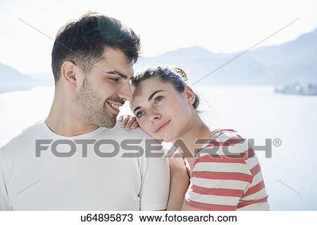 Young couple in front of lake and mountains View Large Photo Image Stock Image - Young couple in front of lake and mountains. Fotosearch