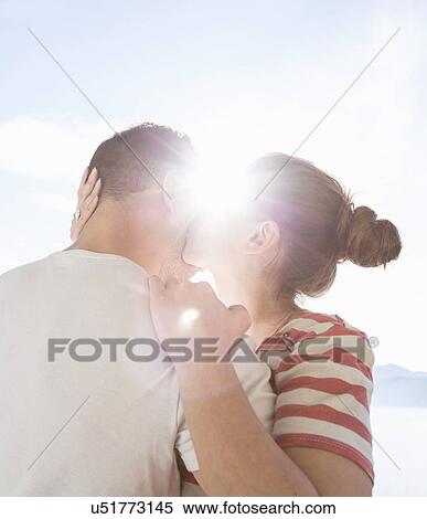 Stock Photography - Young couple kissing. Fotosearch