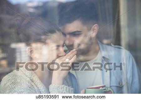 Stock Image - Young couple sharing a joke. Fotosearch