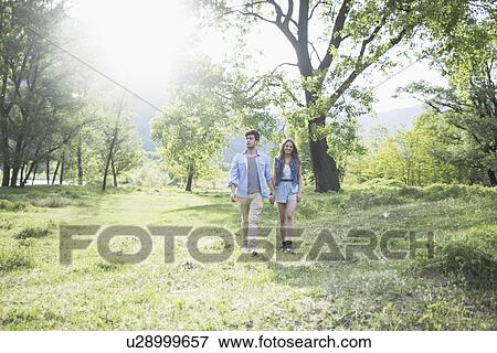 Young couple strolling in sunlight, Piemonte, Italy View Large Photo Image Stock Photo - Young couple strolling in sunlight, Piemonte, Italy. Fotosearch