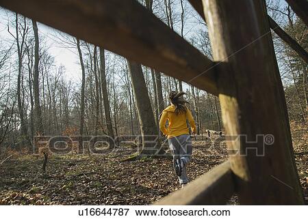 Stock Photo - Young female running in forest. Fotosearch