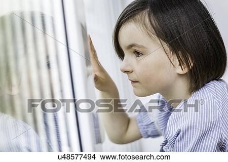 Young girl looking out of window View Large Photo Image Picture - Young girl looking out of window. Fotosearch
