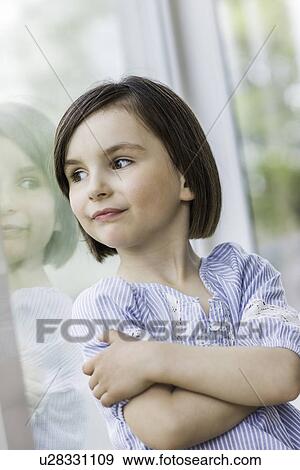 Young girl looking out of window View Large Photo Image Stock Photo - Young girl looking out of window. Fotosearch
