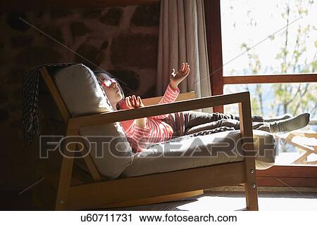Young girl sitting on rocking chair daydreaming View Large Photo Image Stock Image - Young girl sitting on rocking chair daydreaming. Fotosearch