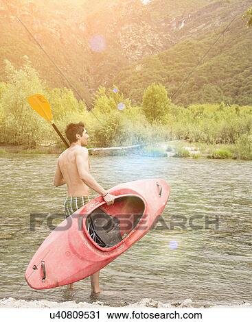 Young man with canoe on Toce riverbank, Piemonte, Italy View Large Photo Image Stock Image - Young man with canoe on Toce riverbank, Piemonte, Italy. Fotosearch