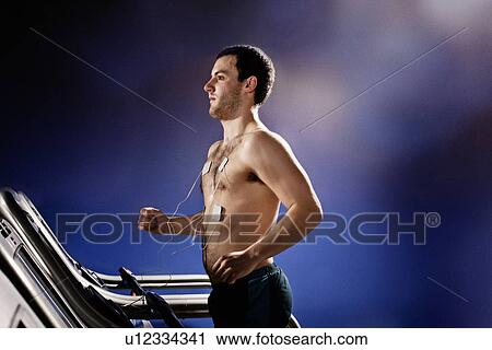 Young man with heart rate monitor running on gym treadmill in altitude centre View Large Photo Image Stock Image - Young man with heart rate monitor running on gym treadmill in altitude centre. Fotosearch