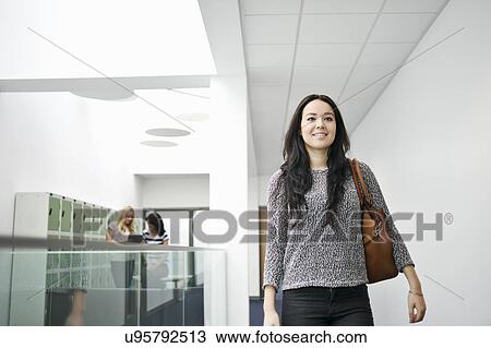 Young woman in corridor View Large Photo Image Stock Image - Young woman in corridor. Fotosearch