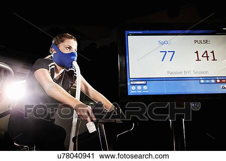 Young woman in face mask on gym exercise cycle in altitude centre View Large Photo Image Stock Image - Young woman in face mask on gym exercise cycle in altitude centre. Fotosearch