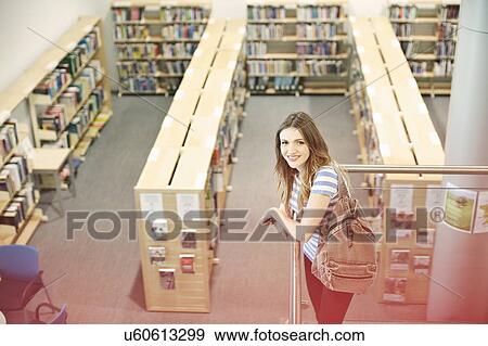 Young woman in university library, high angle View Large Photo Image Stock Photo - Young woman in university library, high angle. Fotosearch