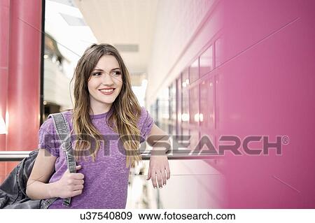Stock Photo - Young woman looking away, smiling. Fotosearch