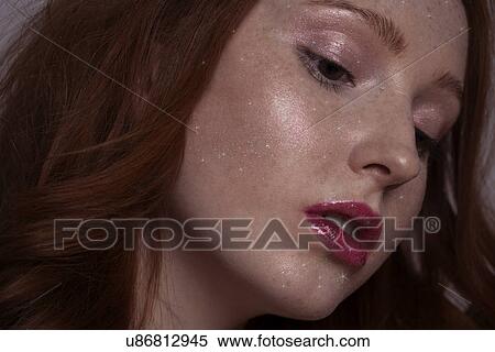 Stock Photography - Young woman looking down. Fotosearch